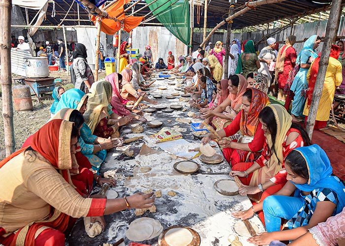 Devotees prepare "Langar" (free meals) which was served on the 550th birth anniversary of Sikh Guru Nanak Dev Ji, at Shahid Minar Maidan, in Kolkata.