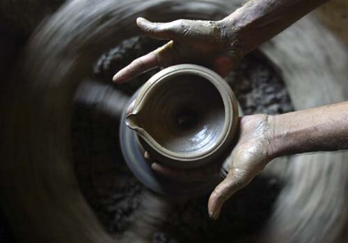 <b>The wheel of joy</b>: A villager makes earthen lamps to be sold on the occasion of Diwali, in Nuagaon village in Bhubaneswar. <I>(AP)</I>