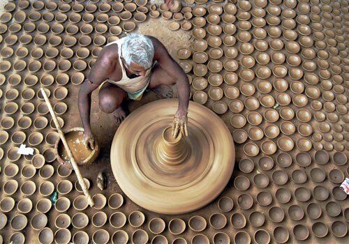 <b>All set:</b> A potter makes earthen lamps to sell during Diwali in Allahabad. <I>(AP)</I>