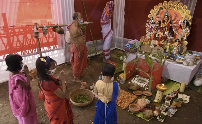 Children offer prayers at a community pandal during the Maha Saptami of Durga Puja, in Guwahati. Durga Puja gives the unity and oneness of India a new glow and new colour, PM Modi said.