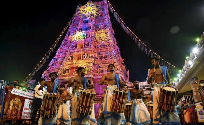 Musicians from Kerala play tradional drums during Durga Puja procession at Kanaka Durga temple in Vijayawada. The festivities are low-key due to the Covid-19 pandemic this year.