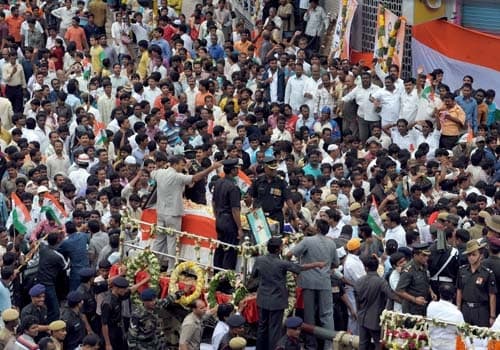 Y S Jagan Mohan (top L) , Congress MP and son of Y S Rajasekhara Reddy, gestures to supporters during a funeral procession in Hyderabad. (AFP Photo)