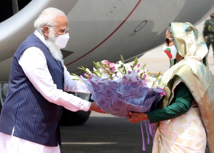 Bangladesh's Prime Minister Sheikh Hasina (R) greets Prime Minister Narendra Modi at the Hazrat Shahjalal International Airport in Dhaka on March 26, 2021. (AFP)