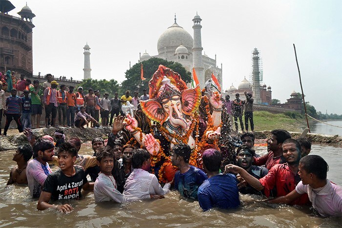 People immerse Lord Ganesha idol, marking the end of Ganesh Utsav celebrations, at Dussehra Ghat in Agra