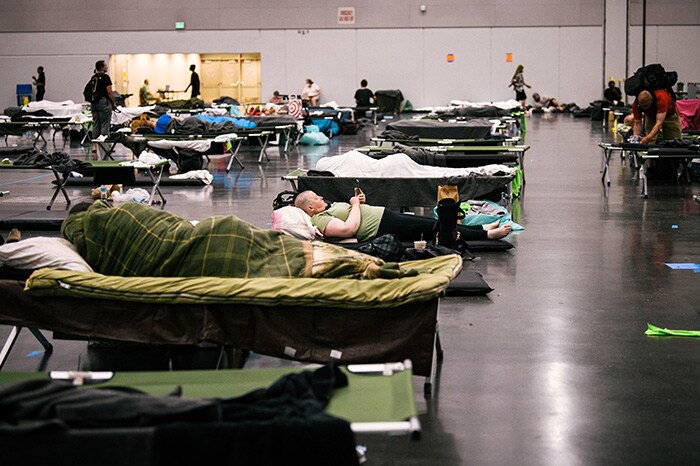 People rest at the Oregon Convention Center cooling station in Oregon, Portland.