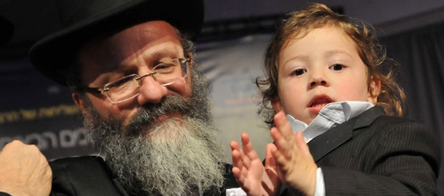 Moshe Holtzberg, the son of Rabbi Gavriel Holtzberg and his wife Rivkah who were killed in the 26/11 attacks, turns three. He is seen here at his Halakah ceremony in Kfar Chabad near Tel Aviv in Israel. The Holtzbergs and four others were killed at Chabad House in Mumbai on November 28 last year.  Moshe was rescued by his Indian nanny Sandra Samuel and is being raised in Israel by his grandparents.<br><br>Halakah is a Jewish tradition during which a child's hair is cut for the first time at the age of three. (AFP Photo)