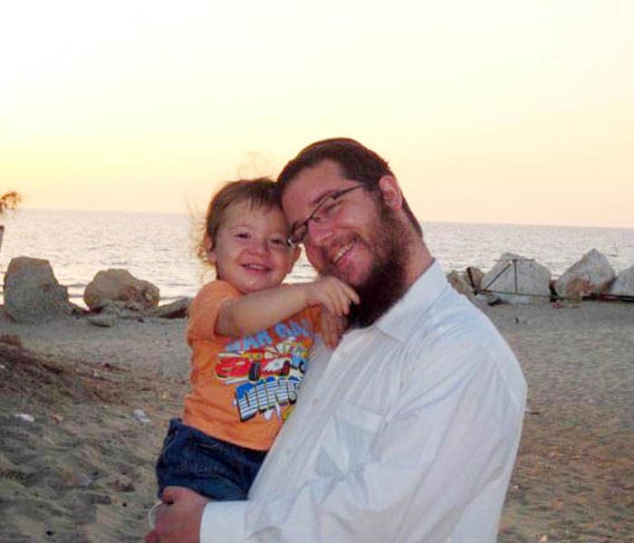 Moshe Holtzberg, seen here with his father Rabbi Gavriel Holtzberg in happier times on a Mumbai beach. Rabbi Gavriel Holtzberg was an Orthodox Rabbi and a community leader for the local Jewish Indian community and led the Friday-night Shabbat services at the Knesset Eliyahoo synagogue.(AFP Photo)