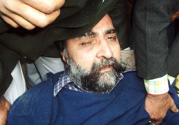 <span class="lh16 fa fs12 fb">Moninder Singh Pandher is helped back on his feet as he lies on the ground after leaving a court in Ghaziabad on January 25, 2007. In a dramatic brawl, lawyers and bystanders beat unconscious one of two suspects after the pair were remanded in custody over the gruesome Nithari Killings. (AFP Photo)</span>