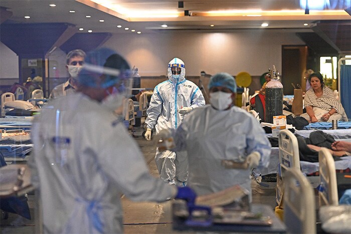 Health workers in PPE suits at a banquet hall turned into a coronavirus care center after surge in cases in New Delhi