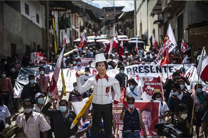 Supporters of the Peruvian left-wing presidential candidate for the Peru Libre party, Pedro Castillo, march in Tacabamba, Cajamarca region, northeastern Peru, on June 07, 2021, a day after runoff elections.