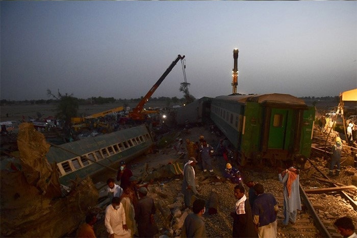 Railway workers operate at the site of a train accident in Daharki area of the northern Sindh province on June 7, 2021, as at least 43 people were killed and dozens injured when a packed Pakistani inter-city train ploughed into another express that had derailed just minutes earlier, officials said.