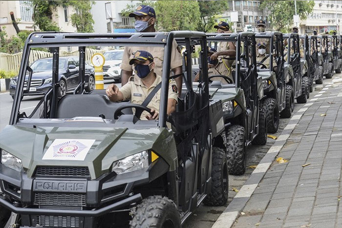 Police personnel sit on their all-terrain vehicle (ATV) used to patrol beaches during its launch in Mumbai on June 7, 2021.