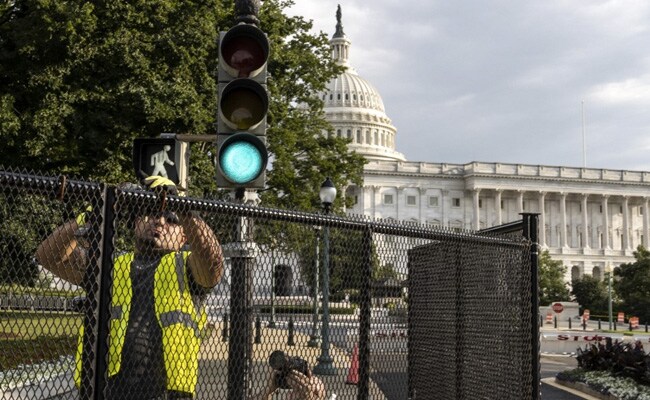 Workers begin the process of taking down a security fence surrounding the U.S. Capitol on July 9, 2021 in Washington, DC. The fence was erected in the wake of the January 6 attack on the Capitol.