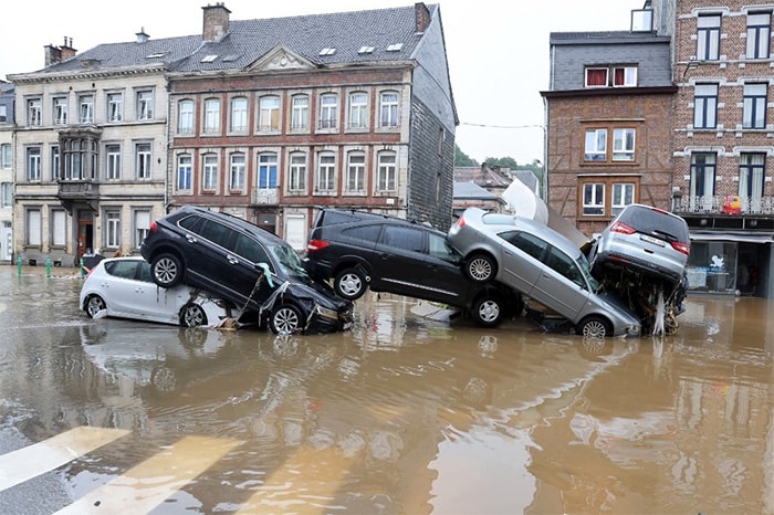 A picture taken on July 15, 2021 shows cars piled up by the water at a roundabout in the Belgian city of Verviers, after heavy rains and floods lashed western Europe.