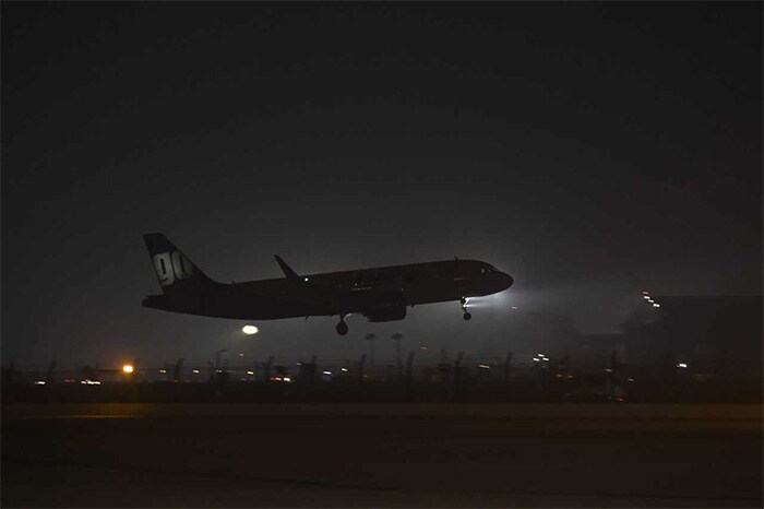 A planes prepares to land under heavy smog condition at the Palam Technical airport in Delhi