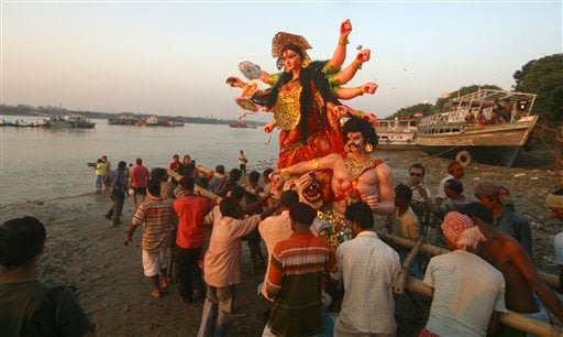 Hindu devotees immerse clay idols of Goddess Durga in River Ganges in Calcutta, India on Sunday.