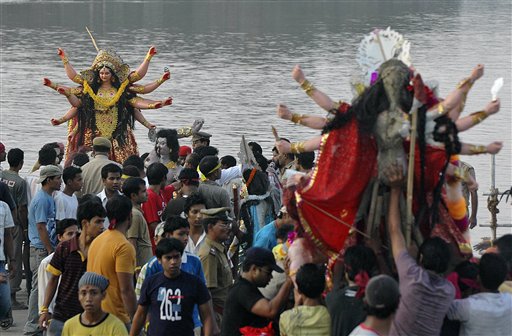 Devotees carry Goddess Durga idols for immersion in River Brahmaputra on the last day of the Durga Puja festival in Gauhati, India on Sunday.