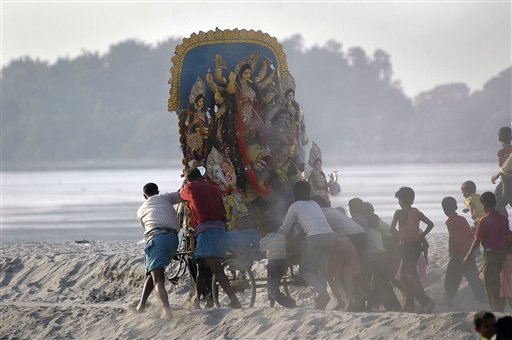 Devotees carry Goddess Durga idol on a cart for immersion along River Brahmaputra on the last day of the Durga Puja festival in Gauhati, India on Sunday.