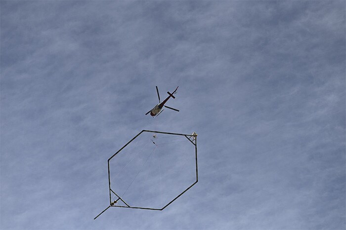 A helicopter equipped with a surface penetrating high definition camera hovers over Tapovan tunnel, where workers are trapped, in Chamoli district.