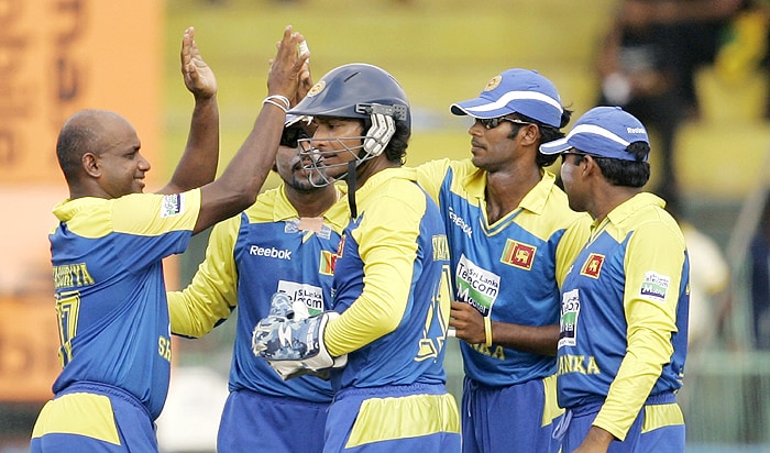 Sri Lankan players congratulate Sanath Jayasuriya for taking the wicket of India's Rahul Dravid during their Tri-Nation Championship Trophy final ODI match in Colombo on Monday. (AP Photo)