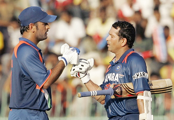Indian captain MS Dhoni congratulates teammate Sachin Tendulkar as he completed a century during the Tri-Nation Championship Trophy final ODI match against Sri Lanka in Colombo on Monday. (AP Photo)