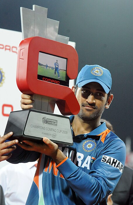 Indian captain Mahendra Singh Dhoni holds the trophy after victory in the Tri-Nation Championship trophy final ODI match against Sri Lanka at the R. Premadasa Stadium in Colombo on Monday. (AFP Photo)