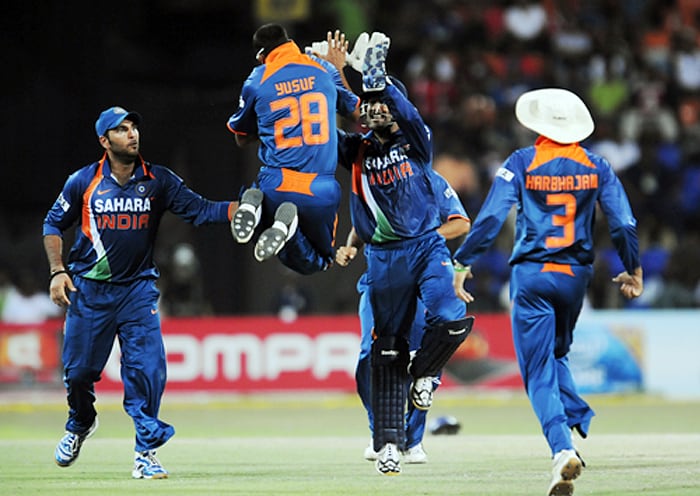 Indian skipper MS Dhoni celebrates with teammate Yusuf Pathan after dismissing Sri Lankan batsman Sanath Jayasuraiya during their Tri-Nation Championship Trophy final ODI match in Colombo on Monday. (AFP Photo)