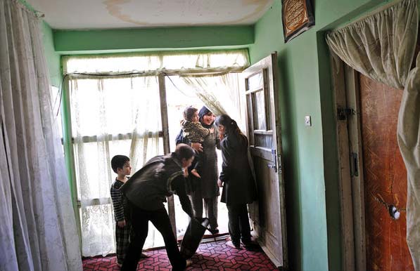 Abada greets her children at home. She says she often finds herself acting her own life out onscreen. Her husband, who is 30 years older than her, is abusive and addicted to opium. They got married when she was 13. (NYT PHOTO)