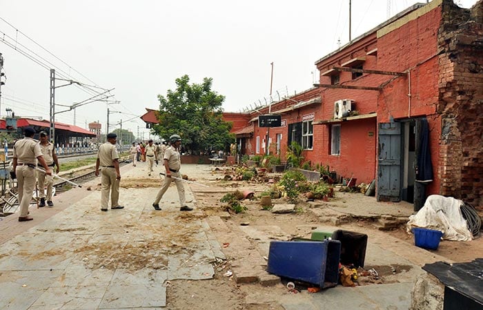 Police personnel at the Danapur Railway Station during a protest against the Agnipath scheme.