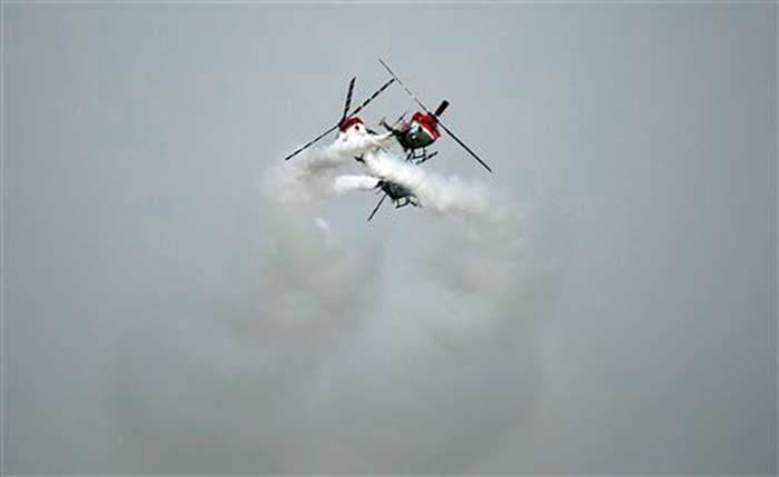 Three Sarang helicopters perform a very complex and daring aerial manoeuvre.