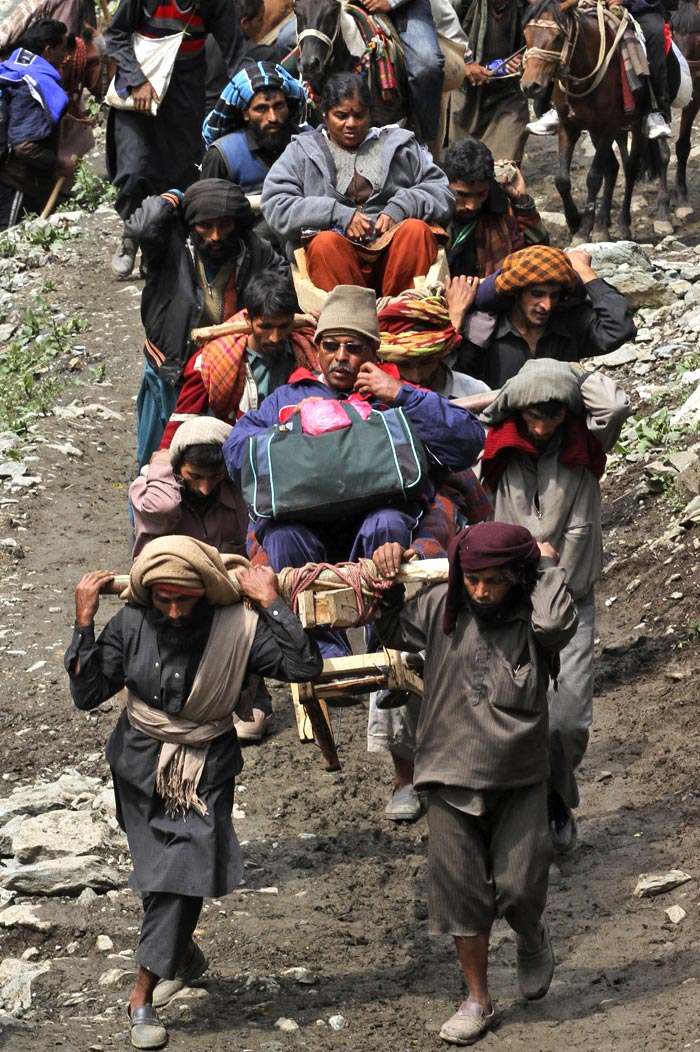 Over 13,000 pilgrims started from Baltal base camp, about 110 km from Srinagar, leading to the 3,880-metre high cave shrine. (AP Photo)