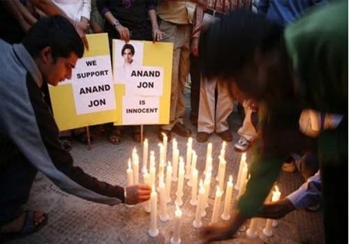 <span class="lh16 fa fs12 fb">Earlier this year, supporters of Anand Jon in New Delhi took out a candle light vigil for a fair trial of the designer. (AP photo)</span>