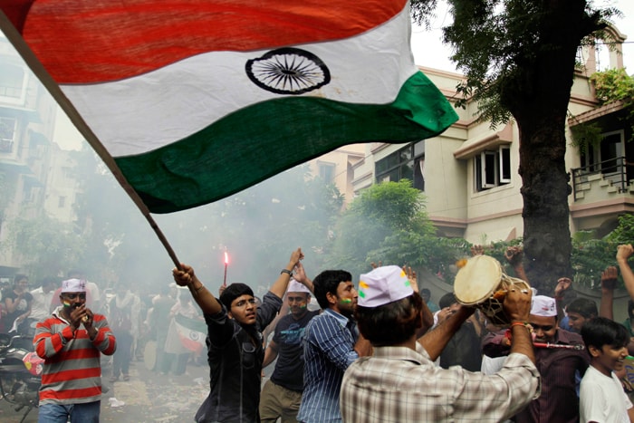 Supporters of Anna Hazare wave the Tricolour and celebrate in Ahmadabad. <br><br>
Anna Hazare ended his 12-day hunger strike on a victorious note on Sunday after the Parliament threw its weight behind the movement against corruption.