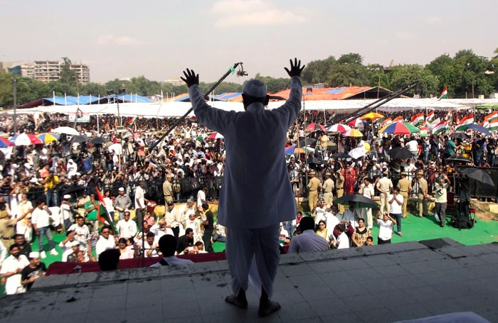 Social activist and Gandhian Anna Hazare gestures to his supporters after breaking his fast on the 13th day of his hunger strike at the Ramlila Ground.
