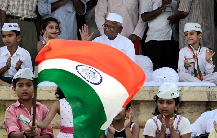 Anna Hazare gestures to his supporters after breaking the fast. The activist also called for electoral reforms and said that people should strive for right to recall and right to reject their MPs in case they failed to perform their duties.