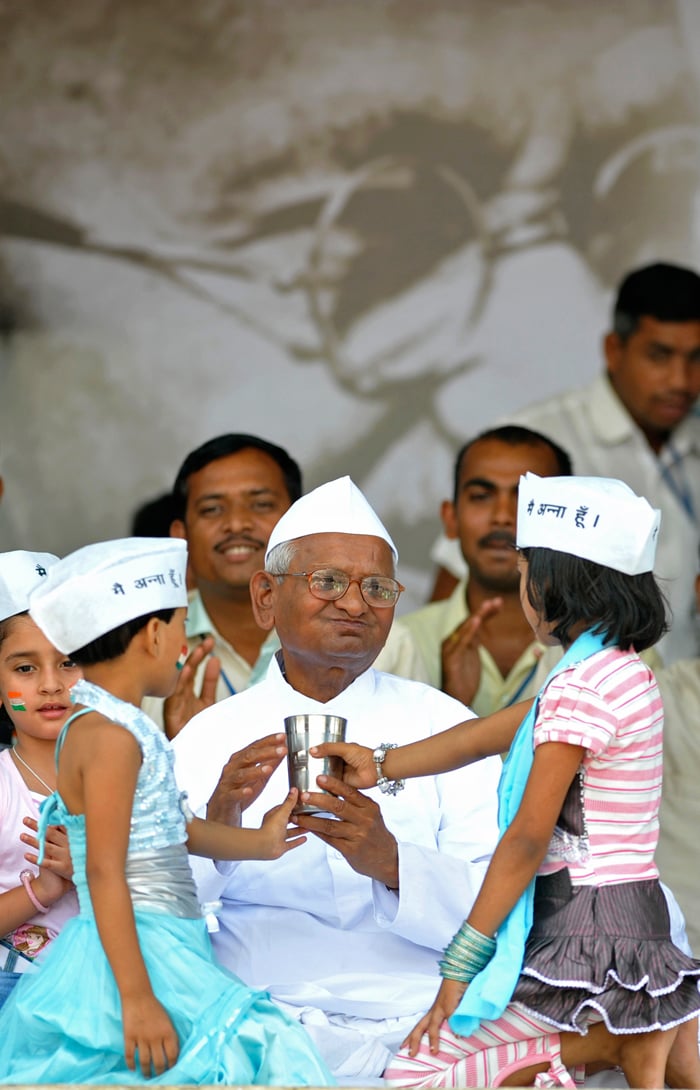 After approximately 290 hours, Anna Hazare ended his hunger strike in Delhi this morning. Two little girls, Ikrah and Simran, with the Tricolour painted on their cheeks and wearing Anna caps, offered him coconut water and honey to bring up the moment.