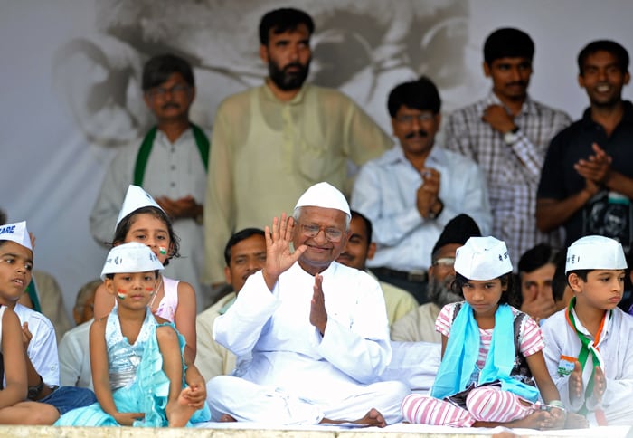 A smiling Anna Hazare acknowledges his supporters.