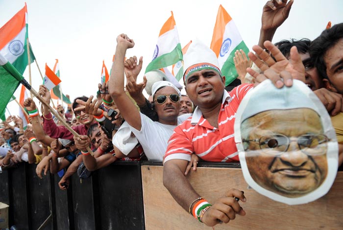 Supporters of Anna Hazare wave the Tricolour at the Ramlila Ground.
