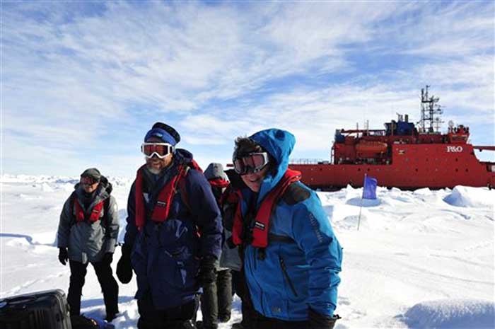 In this photo provided China's official Xinhua News Agency, the first group of passengers who were aboard the trapped Russian ship MV Akademik Shokalskiy arrive at a safe surface off the Antarctic on January 2, 2014.