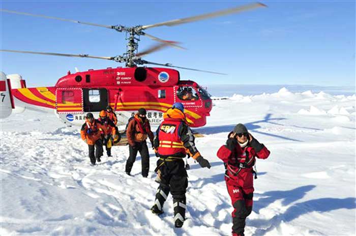 In this photo provided by China's Xinhua News Agency, the first group of passengers who were aboard the trapped Russian vessel MV Akademik Shokalskiy arrive at a safe surface off the Antarctic on January 2, 2014.