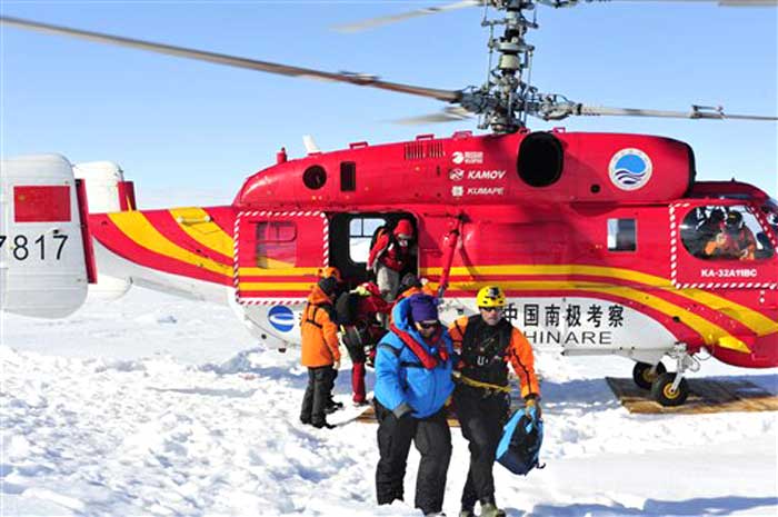 In this photo provided China's official Xinhua News Agency, the first group of passengers of the trapped Russian ship MV Akademik Shokalskiy arrive at a safe surface off the Antarctic on January 2, 2014.