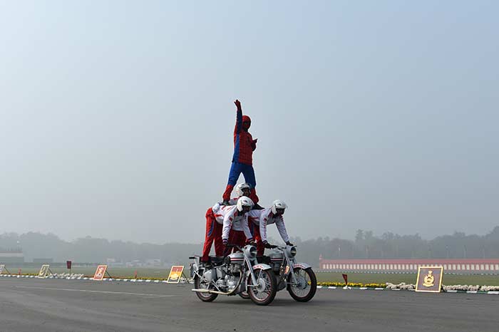 Indian soldiers perform a stunt on motorcycles during the Army Day parade in New Delhi.