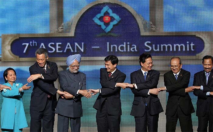 Prime Minister Manmohan Singh joins hands with Leaders of ASEAN countries during a photo session at the 7th ASEAN-India Summit in Hua Hin, Thailand. (PTI image)