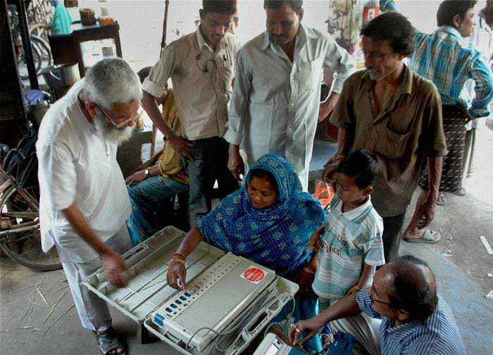 An EVM expert trains people during a training programme in Murshidabad for the upcoming West Bengal Assembly polls. (PTI Photo)