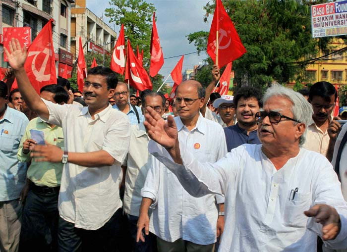 Left Front Chairman Biman Bose (right) takes part in an election campaign for Partha Pratim Biswas (left), the CPI(M) candidate for the Tollygunge LAC seat, in Kolkata ahead of West Bengal assembly polls. (PTI Photo)