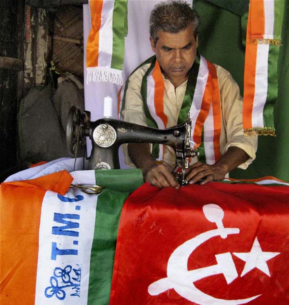 A man stitches flags of political parties in Siliguri ahead of the West Bengal assembly elections. (PTI)