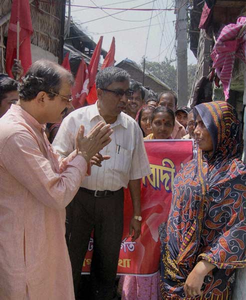 Left Front candidate Nayabaz Mohanta Chatterjee (L) interacts with a woman voter during his campaign in Howrah for the upcoming West Bengal assembly elections. (PTI)