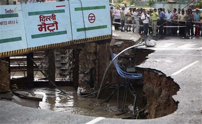 <p>Metro workers and onlookers watch as a portion of road caves-in near the Metro construction site, after a sudden thunder storm early evening in New Delhi, Friday, Aug. 21, 2009. (AP Photo)</p>
<div><font face="Arial" color="#000000" size="2"></font></div>
<div></div>
<a class="fn fl fa fs12" target="_Blank" href="http://www.ndtv.com/convergence/ndtv/new/india.aspx">Seen worse roads? Share pictures with us.</a>