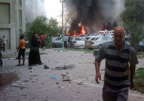 <span class="lh16 fa fs12 fb"><strong>Up in flames:</strong> A blaze rages in front of the Iraqi foreign ministry building following a massive car bomb explosion in central Baghdad on Wednesday. A series of devastating attacks across Baghdad killed at least 75 people, in the worst day of carnage to hit the Iraqi capital since US troops pulled out of the conflict-hit nation's cities. (AFP)</span>