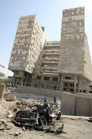 <span class="lh16 fa fs12 fb"><strong>Shattered:</strong> Two young men are seen at the site of a massive explosion outside the Iraqi finance ministry building in the northern Baghdad neighbourhood of Waziriyah. A truck bomb struck outside the finance ministry, destroying part of a bridge near the ministry compound, and leaving 28 people dead and more than 200 injured, nearby hospitals said. The bombing also destroyed water tanks on houses near the ministry, sending water gushing into homes. (AFP)</span>